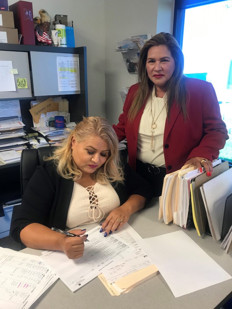 Photo of Anna and Nellie at a desk in the office